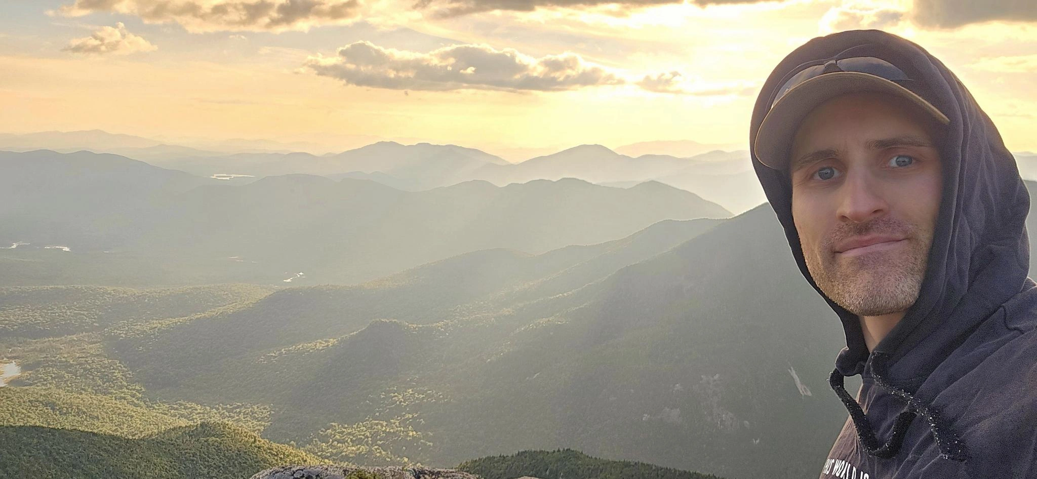 Scott, founder of Hudson Valley Botanicals, standing on Dix Mountain in the Adirondacks